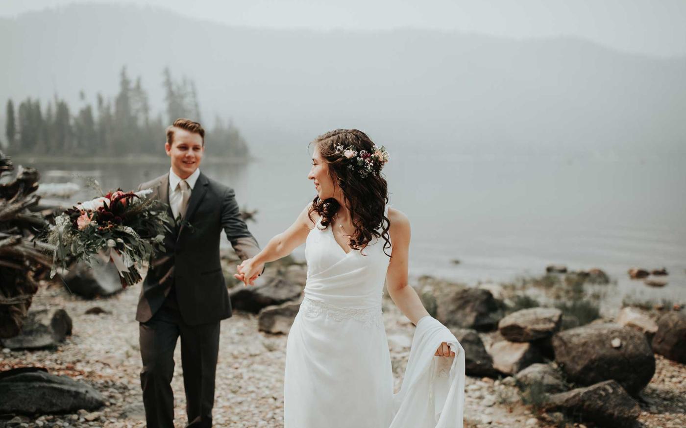 Married couple in front of lake.