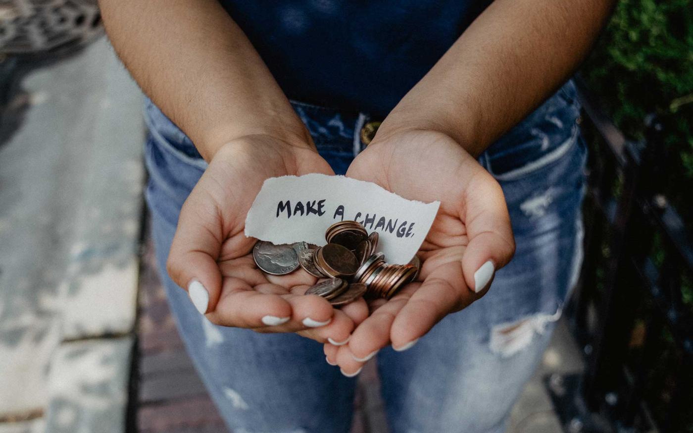 Woman holding coins in hands.